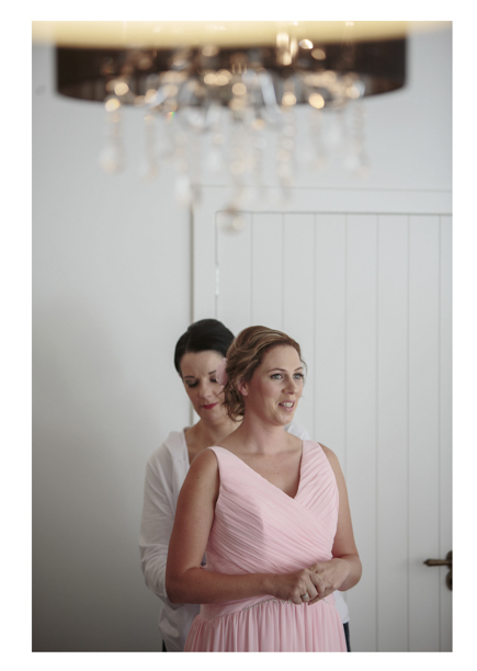 Bridesmaids in pink pleated dress get ready for a wedding at Gracehill Vineyard Estate.