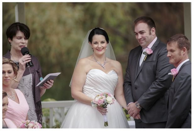 Bride and groom laugh joyfully during wedding ceremony at Gracehill Vineyard Estate