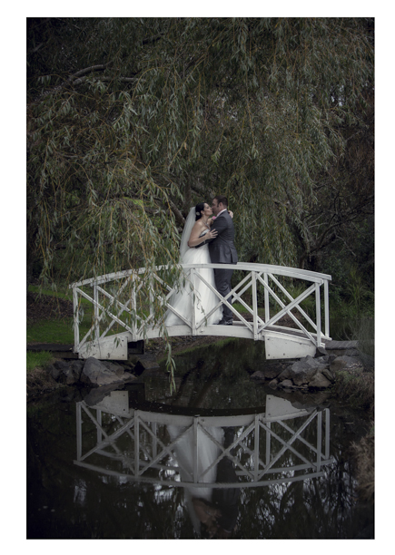 Bride and groom pose on Romeo and Juliet bridge.