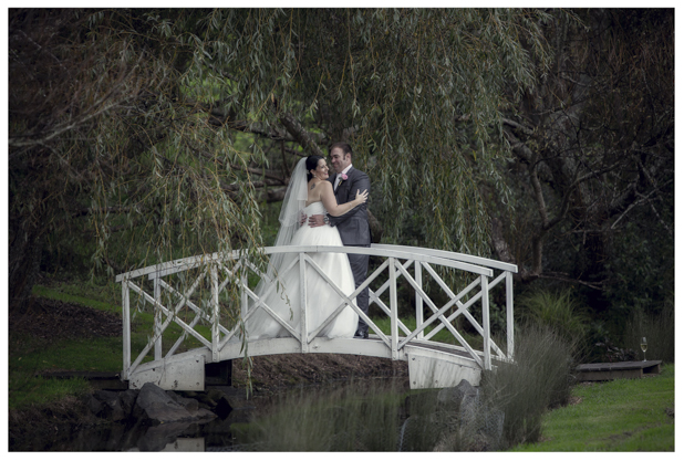 Bride and groom pose on Romeo and Juliet bridge.