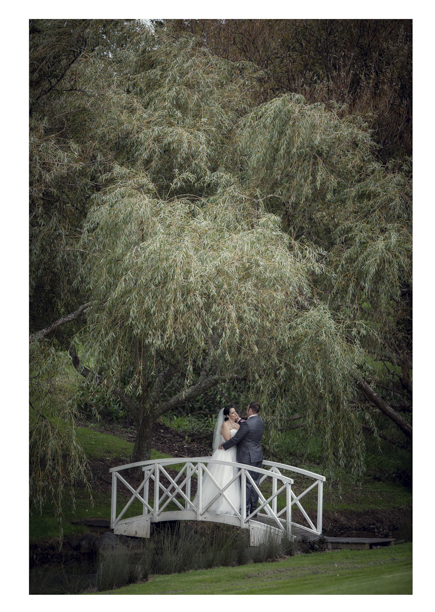 Bride and groom pose on Romeo and Juliet bridge.