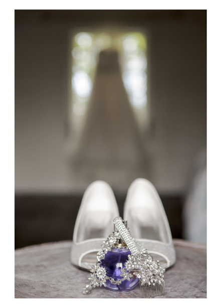 close up photo of wedding shoes and perfume