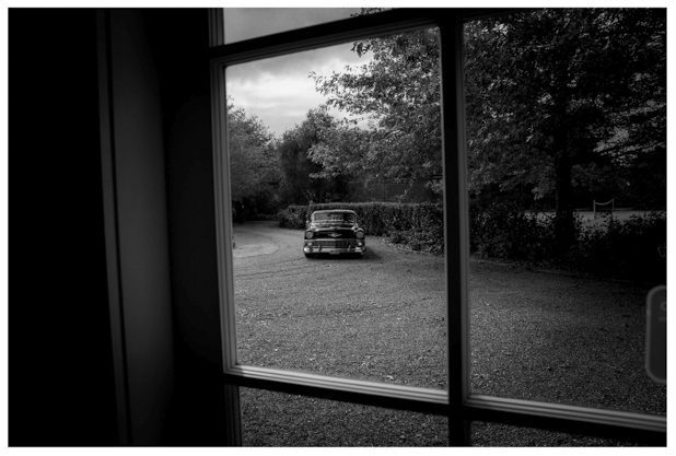black and white photo of classic american wedding photographed through window frame