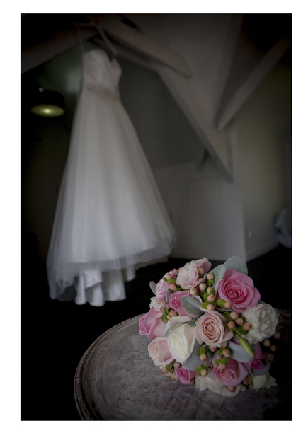 colourful Bridal floral bouquet photo with wedding dress and shoes.