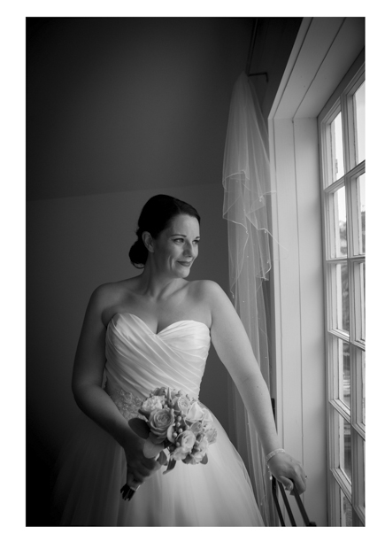 Bride in white wedding dress poses my sash window at Gracehill Vineyard Estate