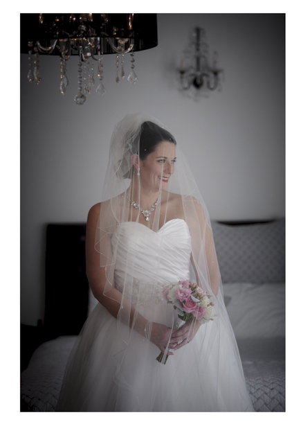 Bride in white wedding dress poses my sash window at Gracehill Vineyard Estate