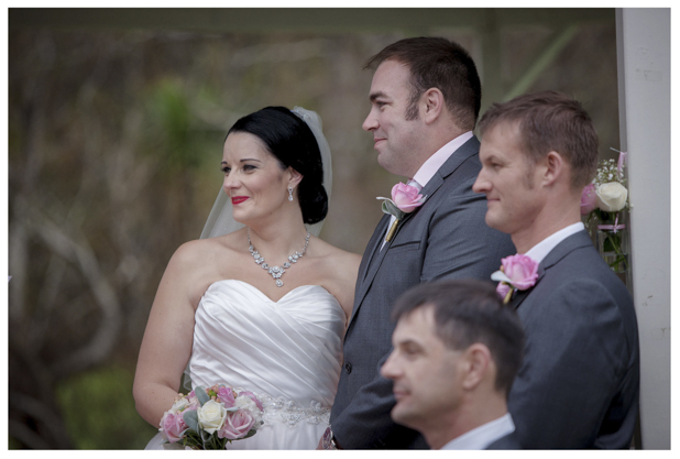 Bride and groom laugh joyfully during wedding ceremony at Gracehill Vineyard Estate
