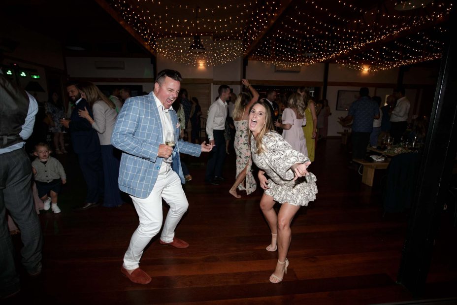 Capturing the moment.Fun couple energetic dancing at wedding reception