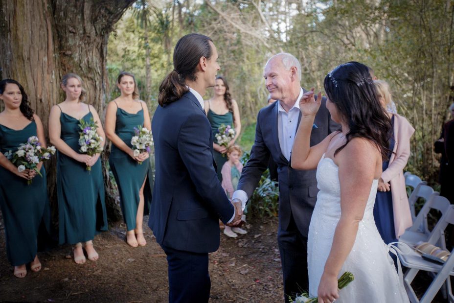 Bride's father greats groom at wedding ceremony