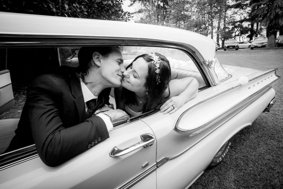 Bride and groom in classic ford wedding car Kumeu