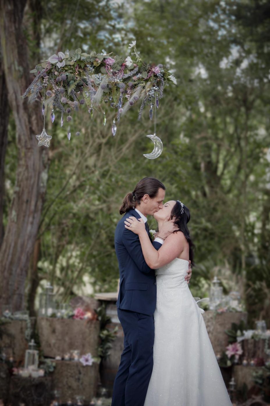 Bride and groom first kiss during ceremony at Kumeu Valley Estate