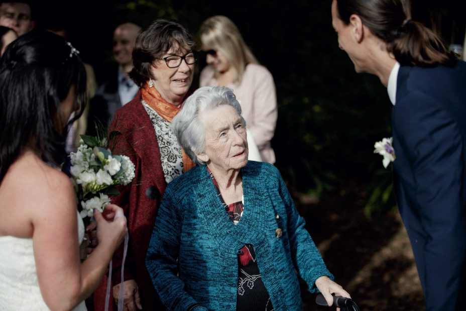 Grandmother congratulate bride and groom after wedding ceremony