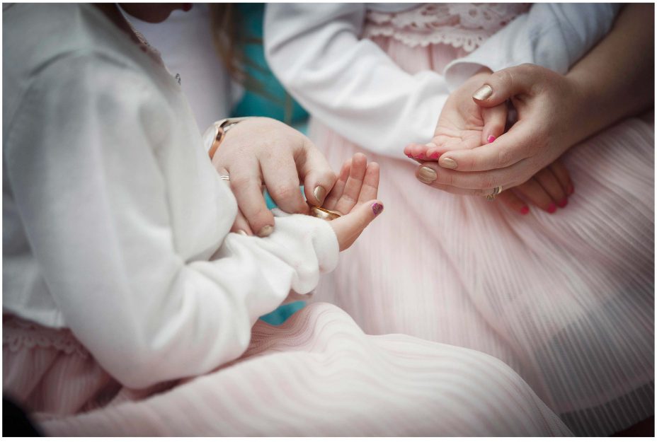 Bridesmaids holding a gold wedding ring