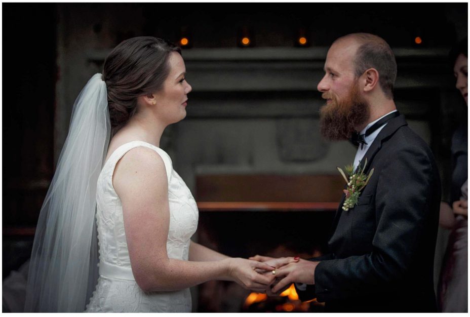 Bride and groom look into each other's eyes and smile during their wedding ceremony at Mantells Mount Eden.v