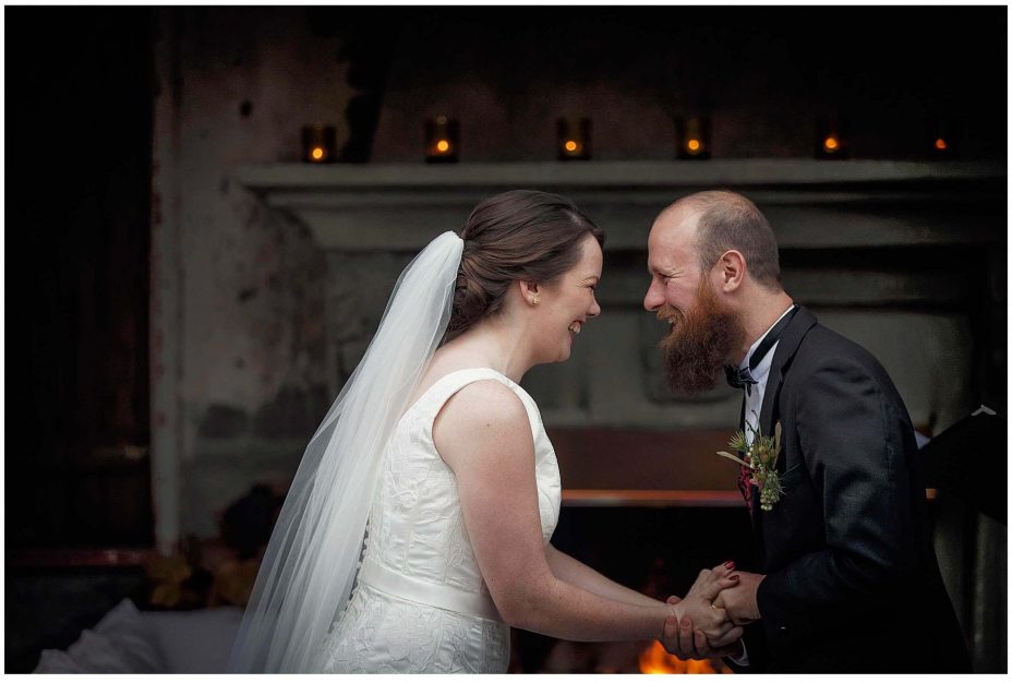 Bride and groom look into each other's eyes and smile during their wedding ceremony at Mantells Mount Eden.v