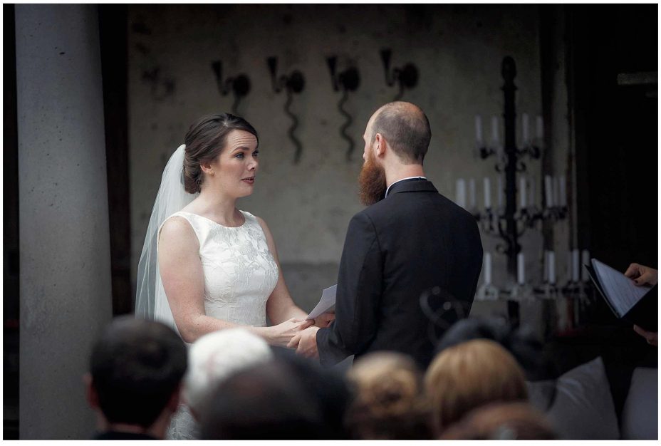 Bride and groom look into each other's eyes and exchange wedding vows during their wedding ceremony at Mantells Mount Eden.