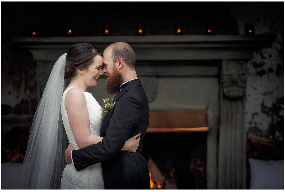 Bride and groom look into each other's eyes and smile during their wedding ceremony at Mantells Mount Eden.v