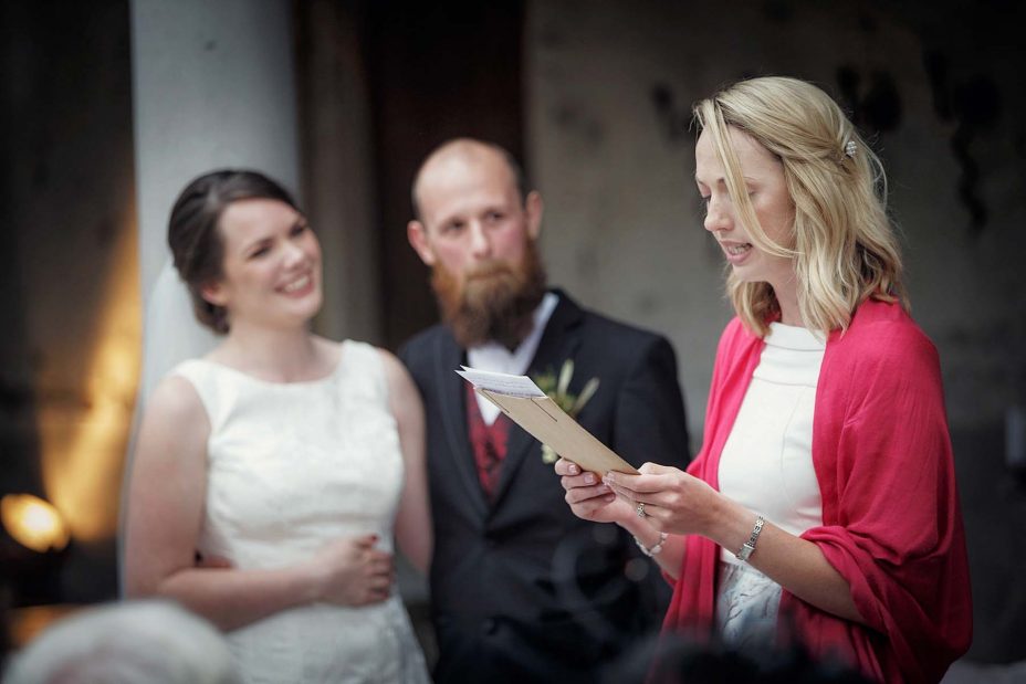 Bride and groom look into each other's eyes and smile during their wedding ceremony at Mantells Mount Eden.v