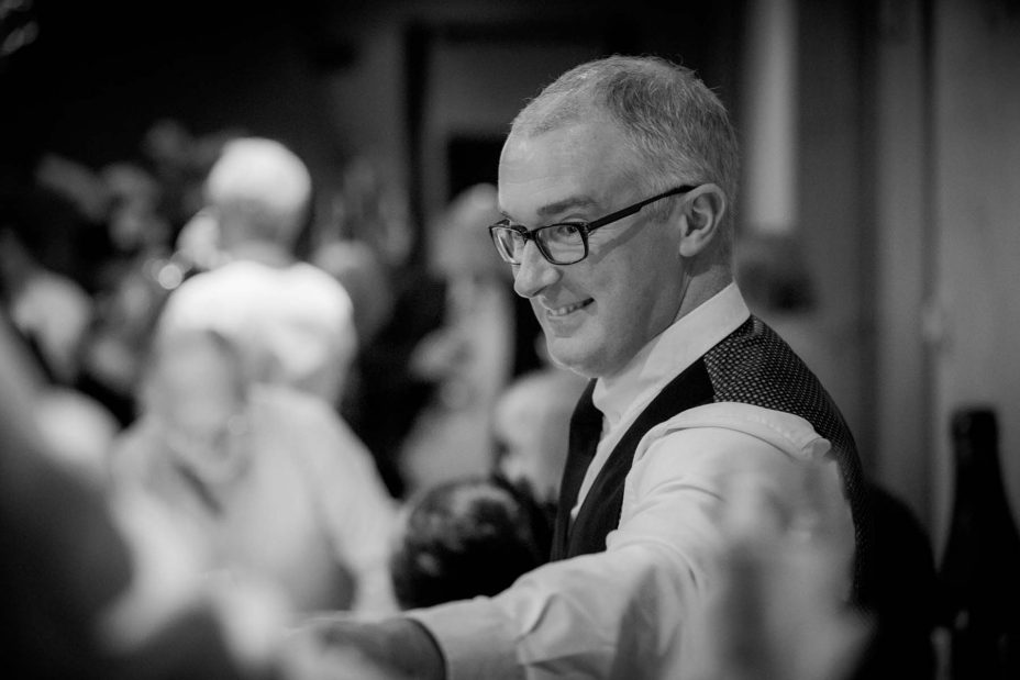 A guest smiles at the speeches during a wedig reception at Mantells in Mount Eden.