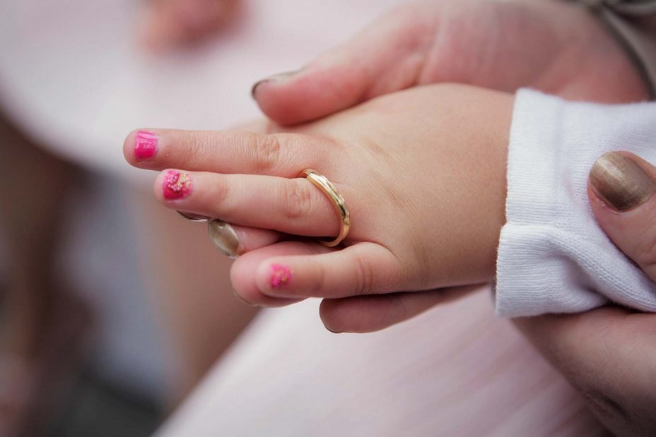 Close up of flower-girl's hand wearing the brides wedding ring during the ceremony at Mantells in Mount Eden.