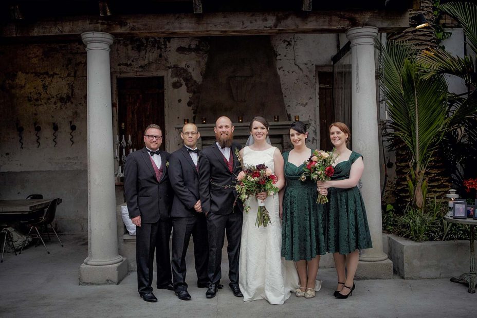 Bridal party group wedding photo infornt of the fireplace the ceremony at Mantells in Mount Eden.