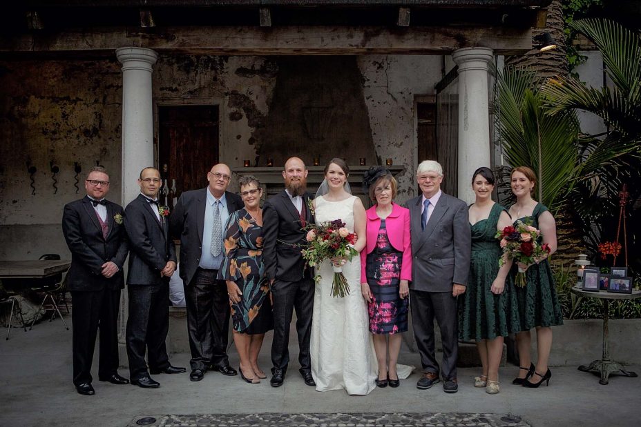 Bridal party group wedding photo infornt of the fireplace the ceremony at Mantells in Mount Eden.