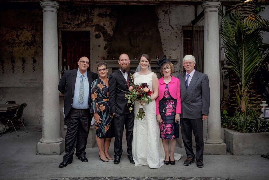 Bridal party group wedding photo infornt of the fireplace the ceremony at Mantells in Mount Eden.