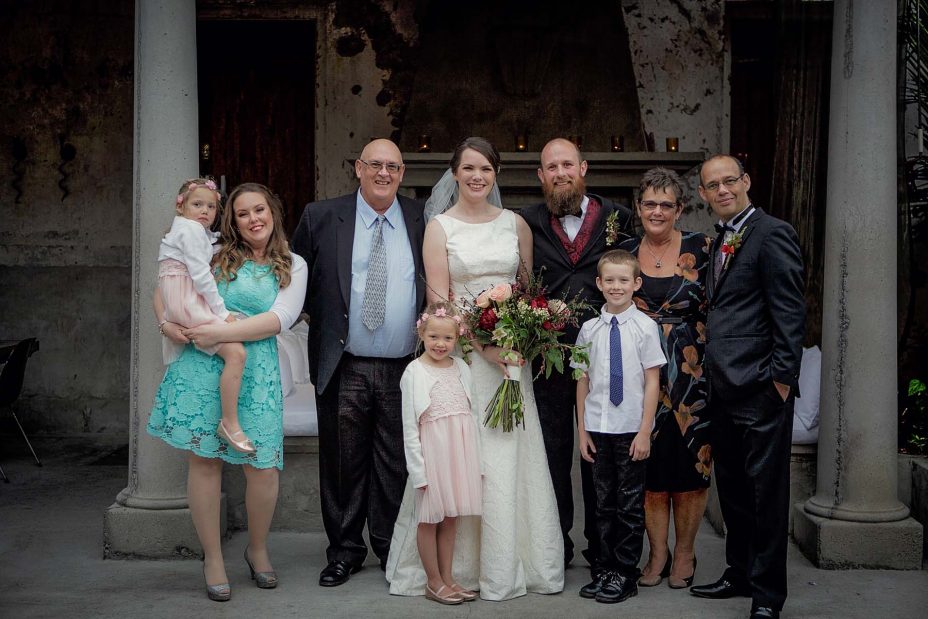 Bridal party group wedding photo infornt of the fireplace the ceremony at Mantells in Mount Eden.