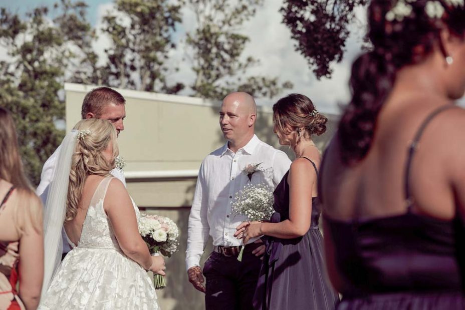 Bride and groom mingling with their wedding guests after their wedding ceremony at Fort Takapuna and the Officers Mess on a sunny summer day in Auckland
